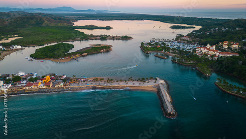 Barra de Navidad Aerial of Jalisco Mexico resort beach town with pacific coastline ocean view at sunset and lake lagoon