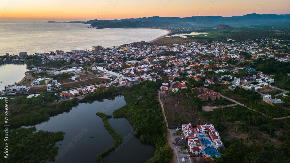 Naklejka premium Barra de Navidad Aerial of Jalisco town beach resort destination in Mexico drone fly at sunset scenic seascape
