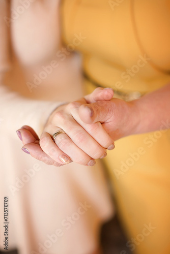 Forever connected Warmth of family close up. Selective focus. Mom and daughter holding hands. Mother's Day concept