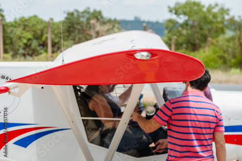 Fotografie Single engine plane with pilot and passenger ready to fly with detail in the for