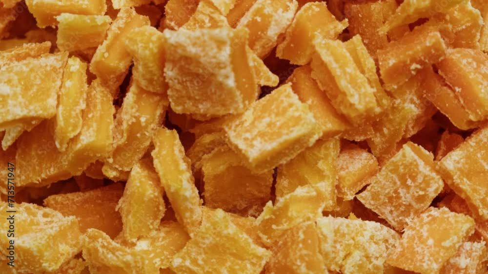 Candied fruits from an orange rotating close-up macro. Citrus dried fruits in sugar Candied fruits from an orange rotating close-up macro. Citrus dried fruits in sugar