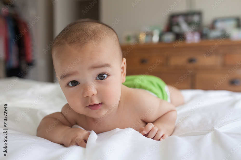 baby laying down on bed topless happily baby laying down on bed topless happily