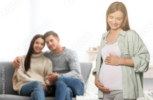 Surrogate mother and intended parents in room photo