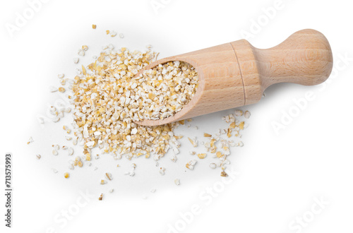 Scoop with raw barley groats isolated on white, top view