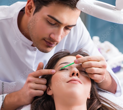 Young woman visiting male doctor cosmetologist