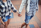 Love, walking and couple holding hands on relax journey, morning trip or weekend tour for outdoor adventure. Fashion, casual clothes and romantic people commute on street, road or sidewalk floor