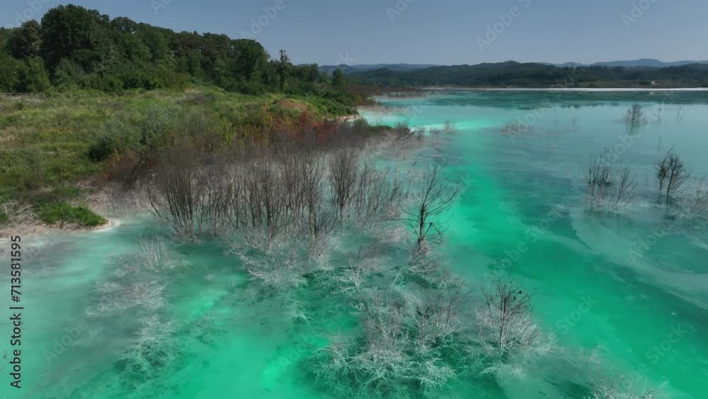 aerial view of green or turquoise polluted water with dirt flowing into a lake from a thermal plant or chemical industry factory aerial view of green or turquoise polluted water with dirt flowing into a lake from a thermal plant or chemical industry factory