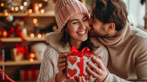 A cheerful couple, deeply in love, unwraps a gift on Valentine's Day.