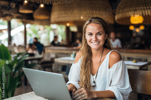 Young Blonde Freelancer With Laptop in a Cafe in Bali, Indonesia
