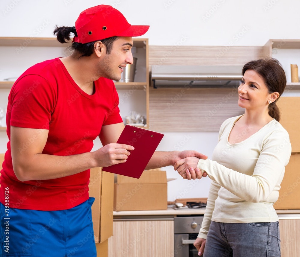 Young male contractor and female customer in moving concept Young male contractor and female customer in moving concept