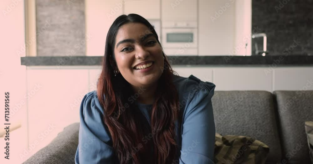 Close up Indian woman sit on sofa greeting friend start remote online talk, share news, enjoy pleasant conversation use videoconference application. E-date services for singles, virtual meeting event