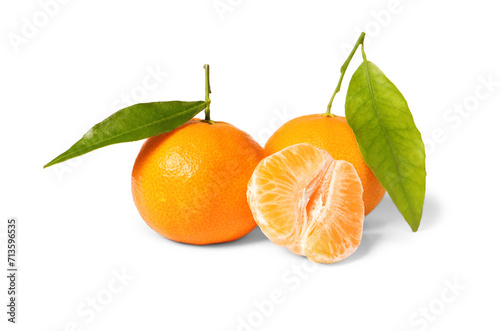 Fresh tangerines with green leaves isolated on white