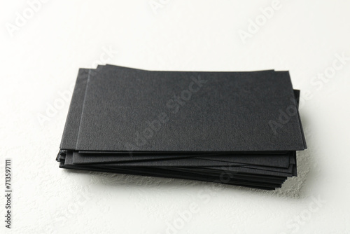 Blank black business cards on white table, closeup