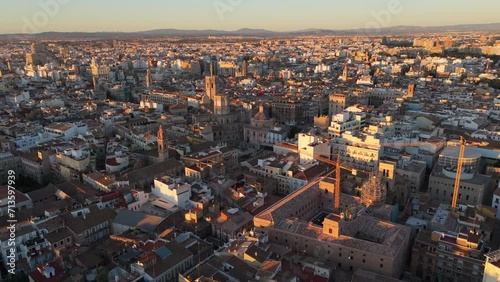 The historic city center of Valencia miquelet bell tower buzzes with life against a backdrop of timeless architecture during the golden hour. Slow Motion, Camera 4K RAW.  photo