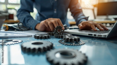 Maintenance engineer working on desk and pointing gears graphic signifies maintenance or inspection of machinery according to service intervals periods and corrective and preventive maintenance photog photo