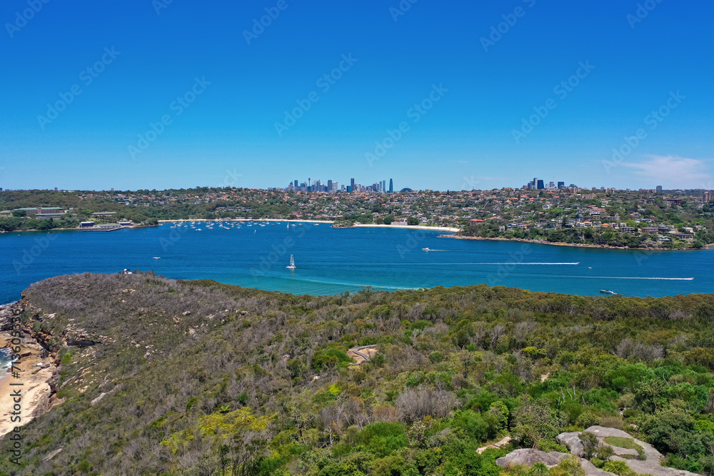 High angle aerial drone view of Balmoral Beach and Edwards Beach in the suburb of Mosman, Sydney, New South Wales, Australia. CBD, North Sydney in the background, Grotto Point in the foreground.