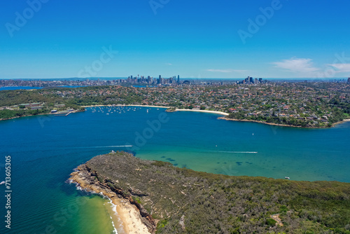 High angle aerial drone view of Balmoral Beach and Edwards Beach in the suburb of Mosman, Sydney, New South Wales, Australia. CBD, North Sydney in the background, Grotto Point in the foreground. © PicMedia