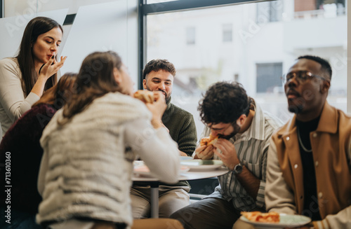 Diverse business team enjoying a pizza lunch break, discussing and relaxing together in a successful workplace.