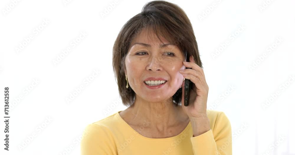 Portrait attractive happy woman looking at camera smiling talking on mobile phone isolated closeup with bright studio lighting. Portrait attractive happy woman looking at camera smiling talking on mobile phone isolated closeup with bright studio lighting.