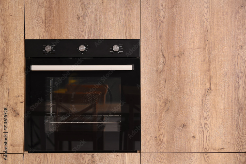 Wooden furniture with built-in oven in modern kitchen Wooden furniture with built-in oven in modern kitchen