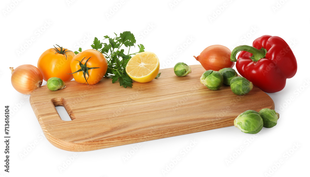 Wooden cutting board with different fresh vegetables isolated on white Wooden cutting board with different fresh vegetables isolated on white