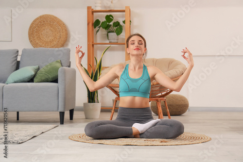 Young woman doing yoga  at ...