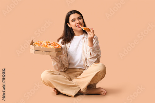 Young woman eating piece of...