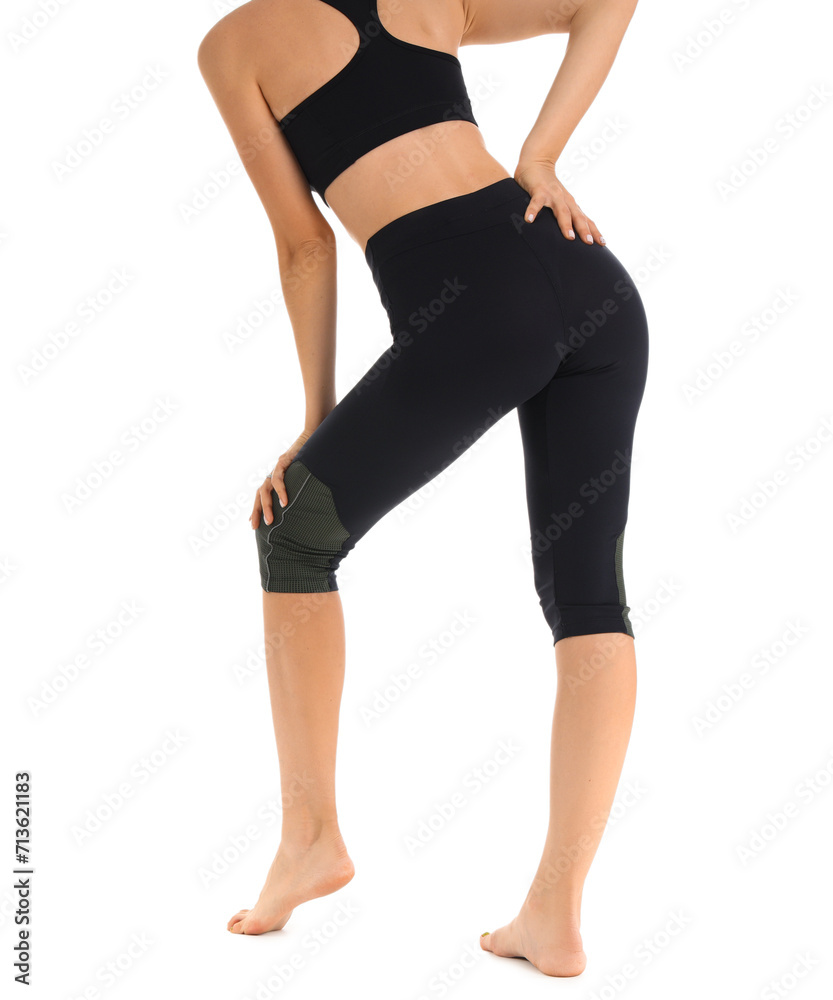 Young woman in black cycling shorts on white background, back view Young woman in black cycling shorts on white background, back view