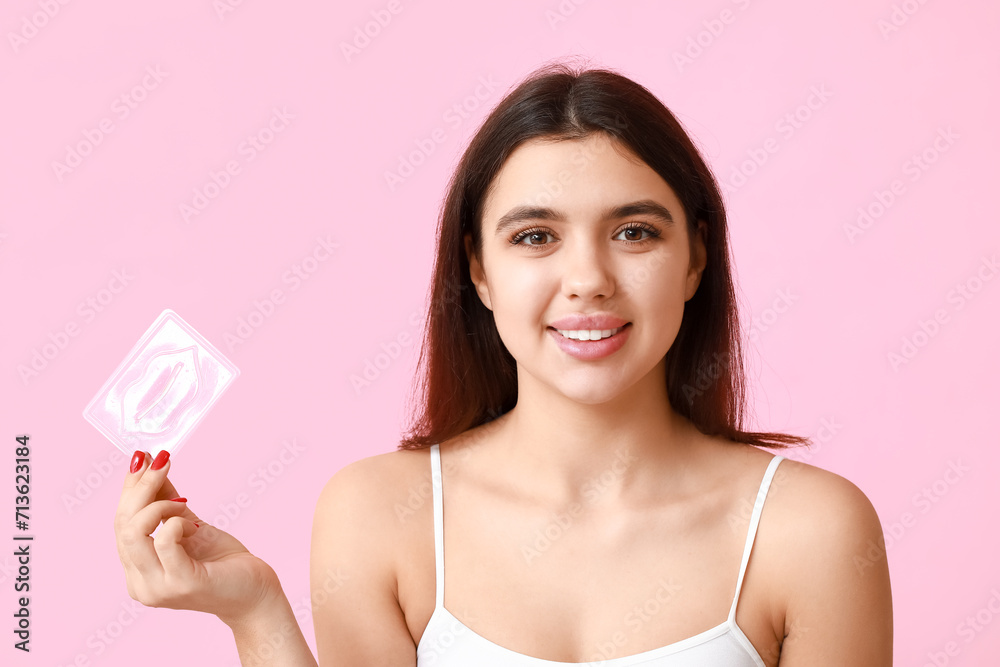 Beautiful young woman with lip mask on pink background Beautiful young woman with lip mask on pink background