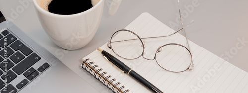 banner in the form of laptop glasses and coffee on a gray background