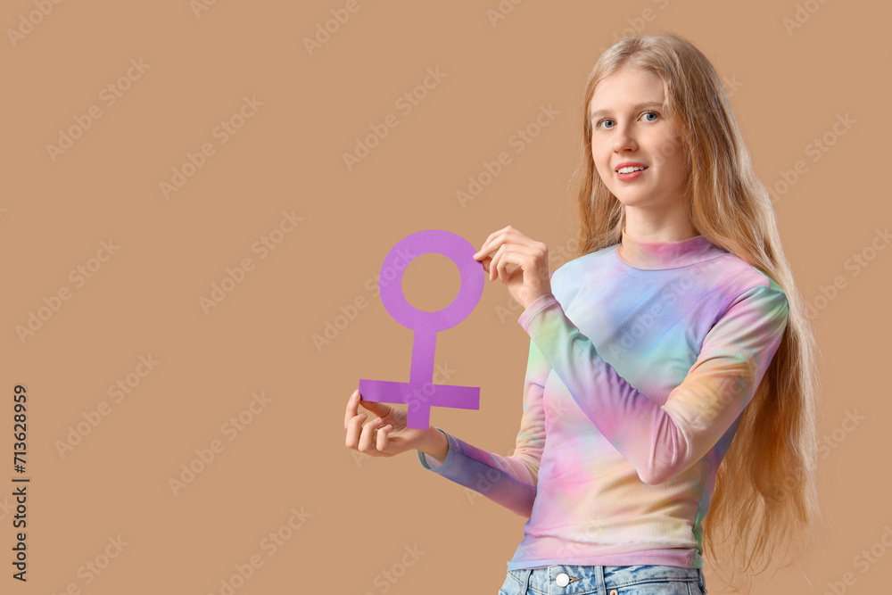 Young woman with gender symbol on beige background Young woman with gender symbol on beige background