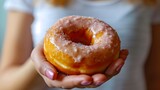 Close-up of a woman's hand holding a delicious donut, background image, generative AI