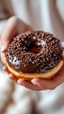 Close-up of a woman's hand holding a delicious chocolate topped donut, background image, generative AI