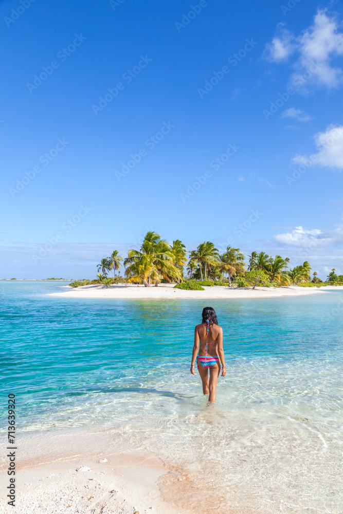 Young woman in bikini in the blue lagoon, Tikehau, French Polynesia Young woman in bikini in the blue lagoon, Tikehau, French Polynesia