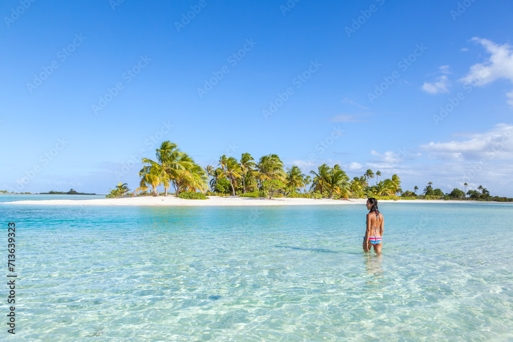 Female tourist in the blue lagoon, Tikehau, French Polynesia Female tourist in the blue lagoon, Tikehau, French Polynesia