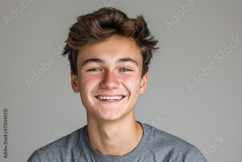 A young man with braces on his teeth smiles for the camera