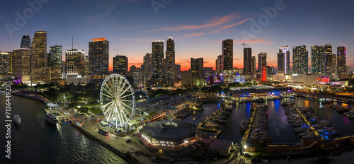 American urban landscape at night. Miami marina and Skyviews Observation Wheel at Bayside Marketplace with reflections in Biscayne Bay water and skyscrapers of Brickell, city's financial center photo