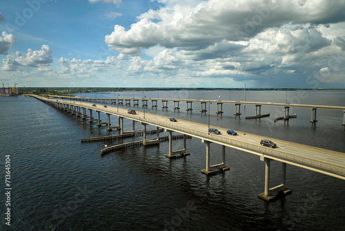 Barron Collier Bridge and Gilchrist Bridge in Florida with moving traffic. Transportation infrastructure in Charlotte County connecting Punta Gorda and Port Charlotte over Peace River photo