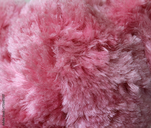 Close up textured background of pink plush fabric material