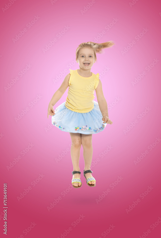 Happy cute girl jumping on color gradient background Happy cute girl jumping on color gradient background