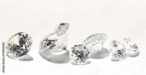 Many beautiful shiny diamonds on white background