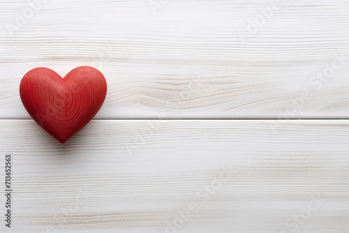 Overhead shot of a small red heart on a white wooden background - romantic concept, copy space - generative ai