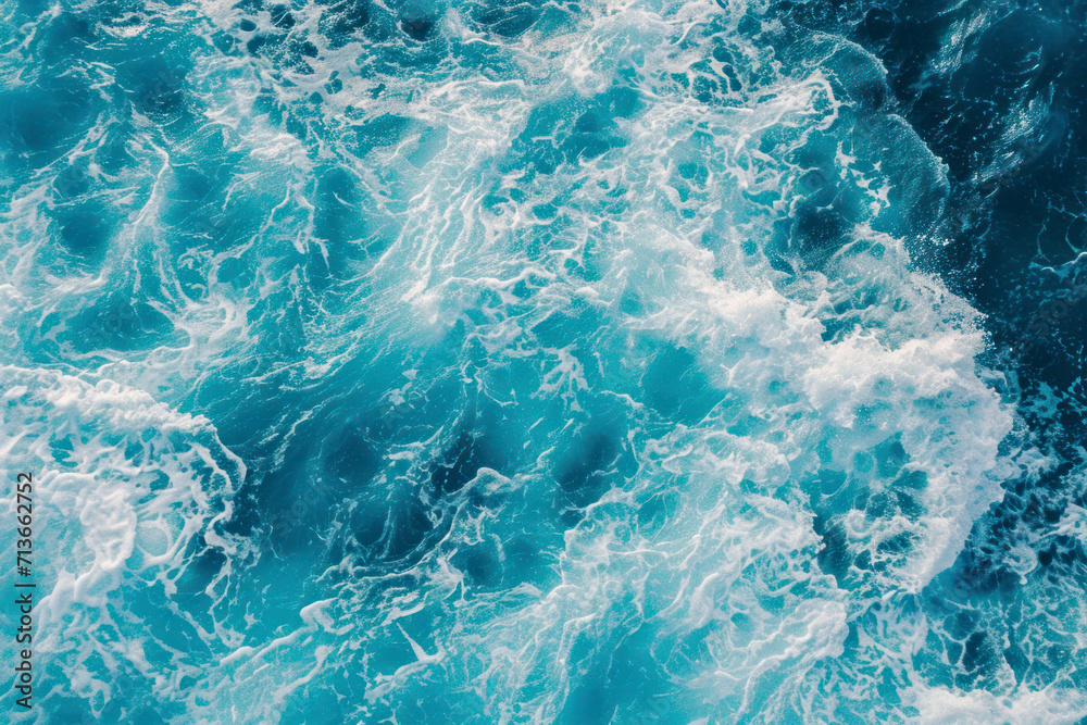 From above aerial view of turquoise ocean water with splashes and foam for abstract natural background and texture. From above aerial view of turquoise ocean water with splashes and foam for abstract natural background and texture.