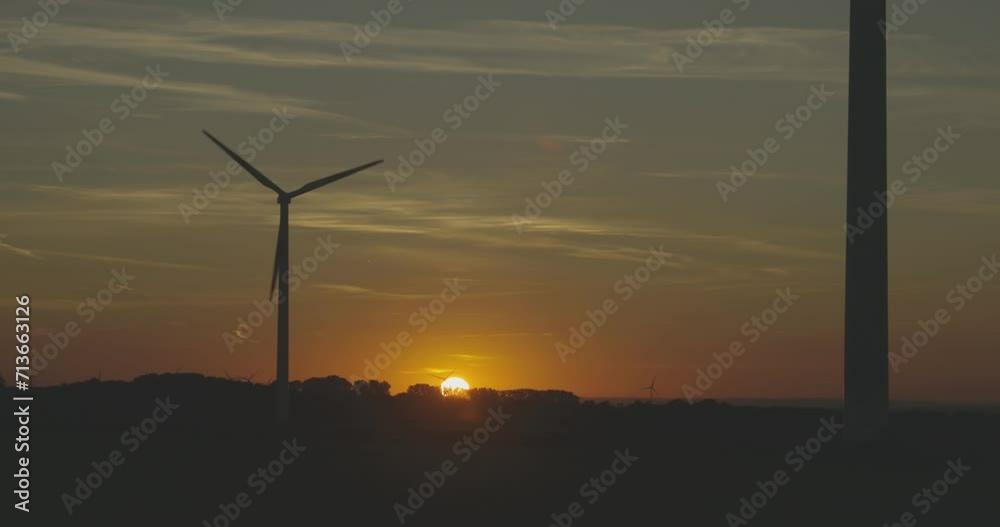 Dahl, Paderborn; Germany - 09/06/2023: Wind turbines in the sunset with the sun behind the wind mill in rural environment. Backlight. Dahl, Paderborn; Germany - 09/06/2023: Wind turbines in the sunset with the sun behind the wind mill in rural environment. Backlight.