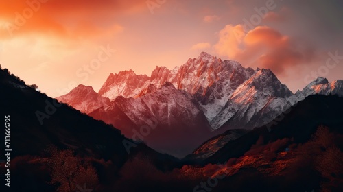 A breathtaking mountain landscape at sunset, with snow-capped peaks, a fiery sky, and a sense of awe and majesty, Photography © CREATIVE STOCK