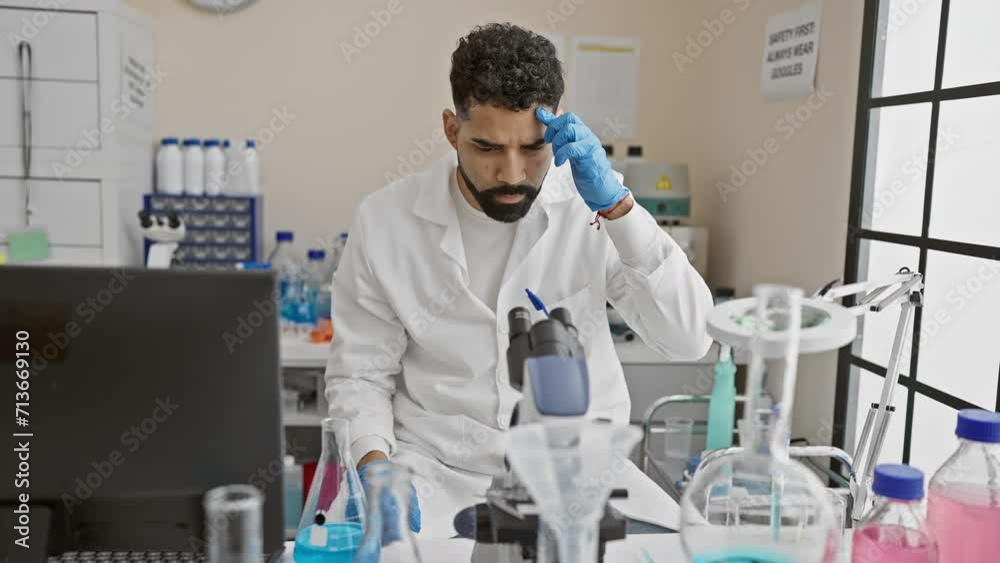 A focused man in a lab coat conducts an experiment with blue liquid in a science laboratory, embodying professionalism and concentration. A focused man in a lab coat conducts an experiment with blue liquid in a science laboratory, embodying professionalism and concentration.