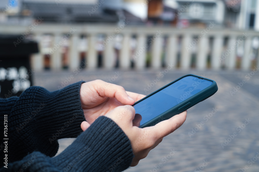 Close-up shot of an woman hand using her smartphone, chatting with someone or scrolling on her phone while relaxing. online communication technology concept.