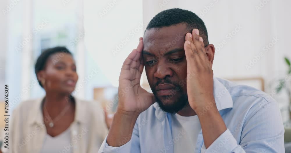 Divorce, stress and couple arguing in house with affair, disaster or cheating crisis at home. Marriage, doubt and man with headache from screaming wife in living room with blame, hate or overthinking