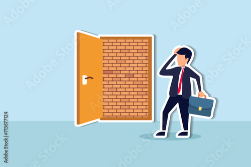 Business dead end, no way to exit or big mistake and wrong decision, obstacle and difficulty to overcome concept, businessman open exit door and found brick wall blocking the way.