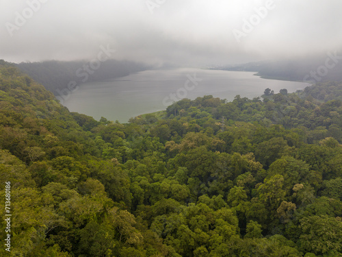 Buyan Lake encompassed by dense forest  in fog and clouds  Bali  Indonesia